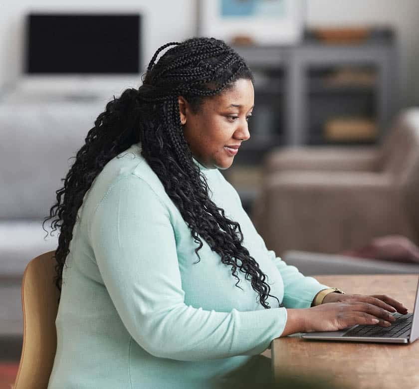 Woman working on a laptop.