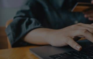 Person using laptop and credit card